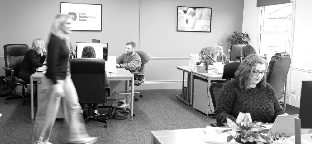 Busy marketing agency workspace showing team collaboration and everyday office activity