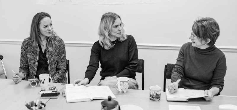 Marketing agency leadership team exchanging insights during a collaborative planning meeting