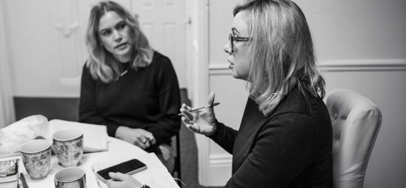 Marketing agency consultant leading a focused strategy discussion with a colleague