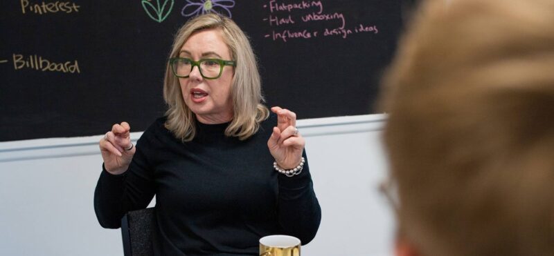 Marketing agency consultant explaining strategy concepts during a team workshop