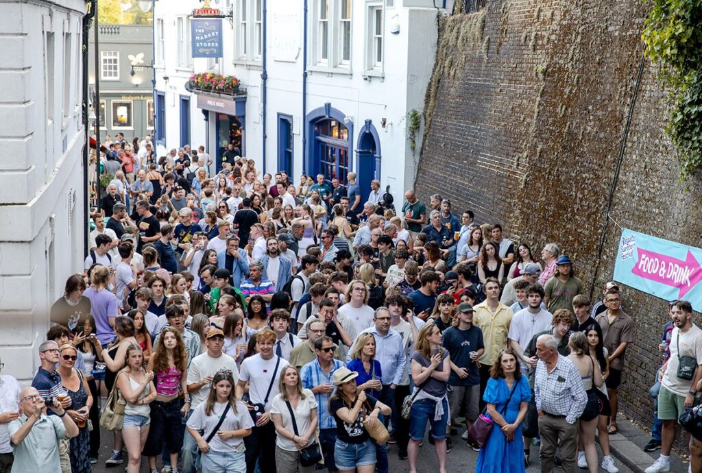People gathered at Tunnel Road in Reigate, enjoying the Reigate Summer Festival. 