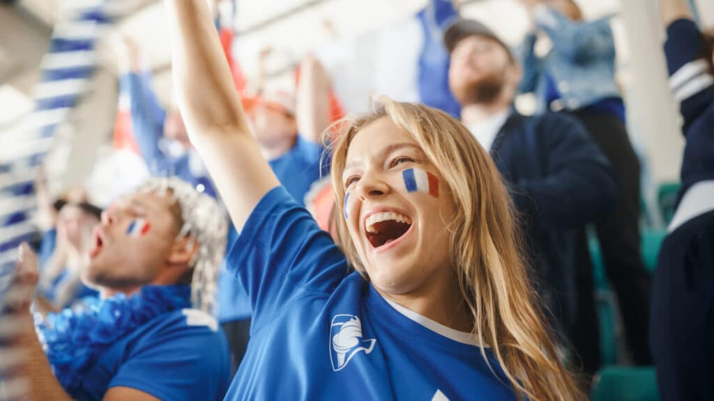 French fans at the World Cup waving flags and cheering