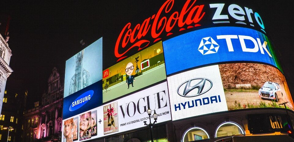 brand identity in saturated markets. London Piccadilly in the evening showing iconic brands with strong brand identity.