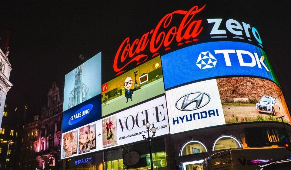 brand identity in saturated markets. London Piccadilly in the evening showing iconic brands with strong brand identity.